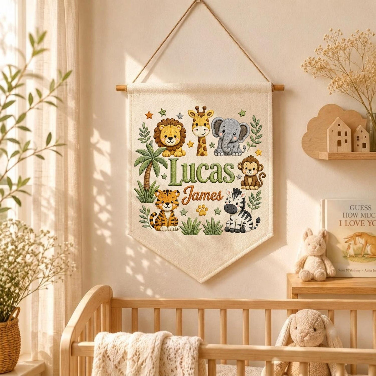 May include: A cream-colored fabric wall hanging banner featuring a colorful illustration of a lion, giraffe, elephant, monkey, tiger, and zebra. The text "Lucas James" is printed in the center in green and brown script and block lettering.
