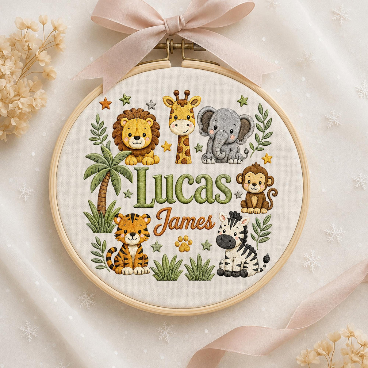 May include: A circular wooden embroidery hoop containing fabric with a stitched design of a lion, giraffe, elephant, monkey, tiger, and zebra. The text "Lucas James" is embroidered in the center, surrounded by palm trees, leaves, and stars.