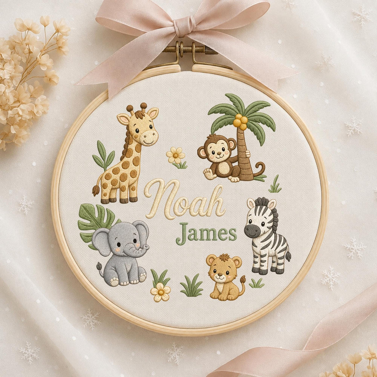 May include: A circular wooden embroidery hoop containing cream fabric with embroidered jungle animals including a giraffe, monkey, elephant, zebra, and lion. The text Noah James is stitched in the center. A light pink ribbon is tied at the top.