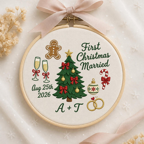 May include: A round wooden embroidery hoop containing white fabric with embroidered designs including a green Christmas tree, a gingerbread man, two champagne flutes, a candy cane, and two gold rings. Text reads First Christmas Married Aug 25th 2026 A + T.