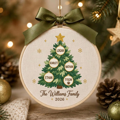 May include: A round embroidery hoop ornament featuring a stitched green Christmas tree with five circular ornaments labeled Logan, Scarlett, Nathan, Ethan, and Tyson. The text The Williams Family 2026 is embroidered below, topped with a dark green satin bow.