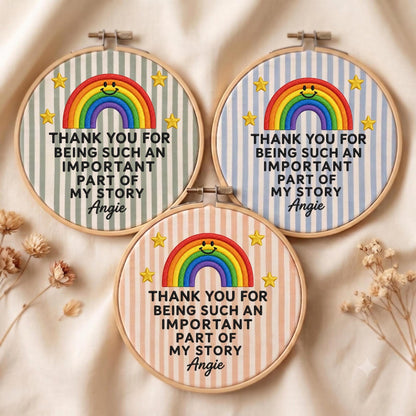 May include: Three circular embroidery hoops featuring striped fabric in sage green, light blue, and peach. Each displays a stitched rainbow with a smiling face, yellow stars, and the text: THANK YOU FOR BEING SUCH AN IMPORTANT PART OF MY STORY Angie.