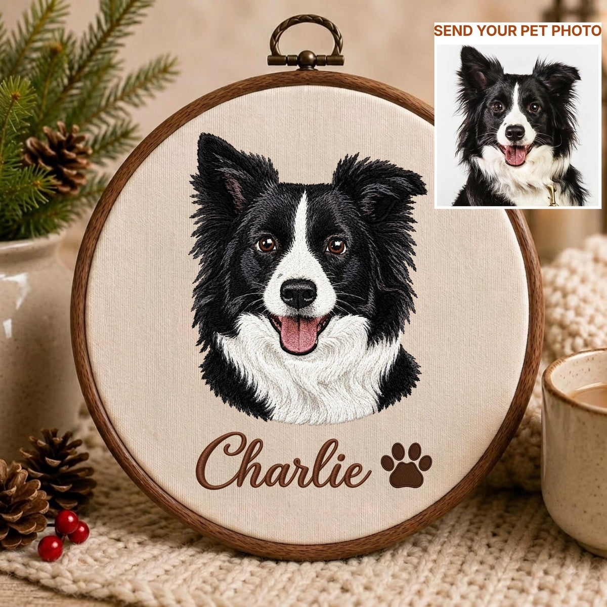 May include: A circular wooden embroidery hoop containing a fabric panel with a stitched portrait of a black and white Border Collie dog. Below the dog, the name Charlie is embroidered in brown script, followed by a brown paw print icon.