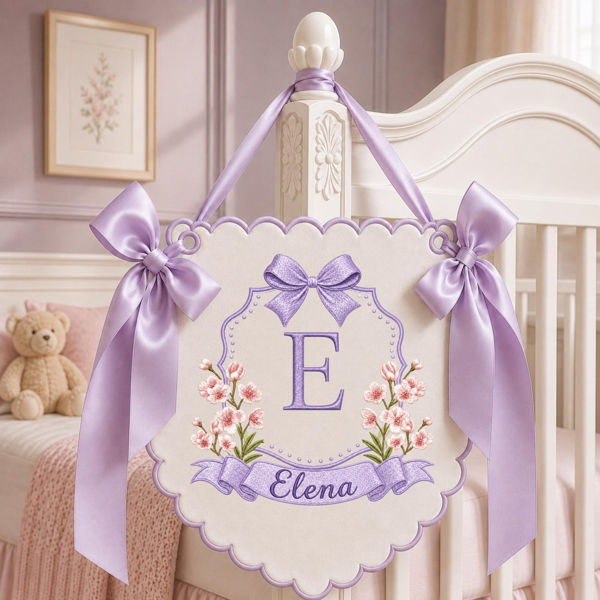 May include: A decorative wall hanging banner featuring a scalloped edge, light purple satin ribbons, and embroidered details. The center displays a large purple letter E, pink floral accents, and a banner with the name Elena in purple script.