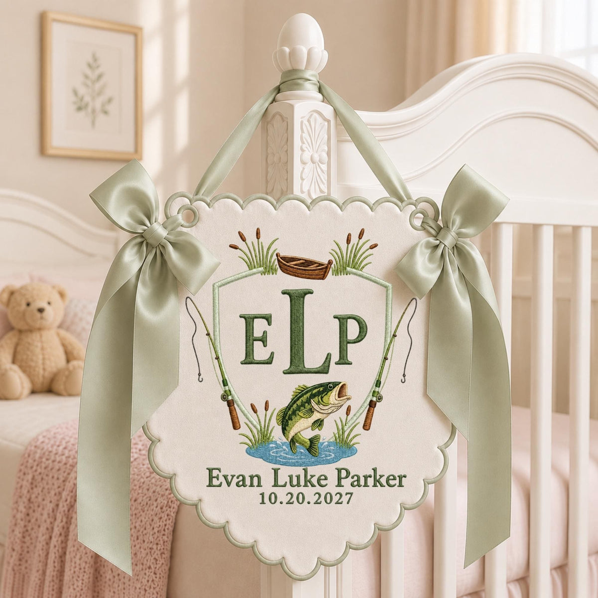 May include: A cream-colored scalloped fabric wall hanging featuring an embroidered fishing theme with a central shield, the letters ELP, a jumping bass, two fishing rods, and a small boat. It includes the text Evan Luke Parker and 10.20.2027.