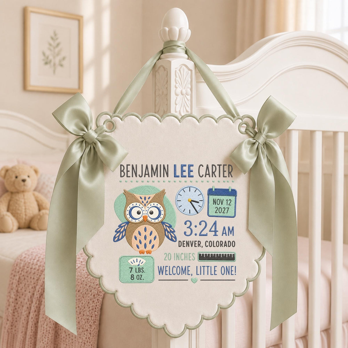 May include: A cream-colored fabric banner with scalloped edges and sage green satin ribbons. It features an owl illustration, the name Benjamin Lee Carter, birth date Nov 12 2027, time 3:24 AM, location Denver, Colorado, 20 inches, and 7 lbs. 8 oz.