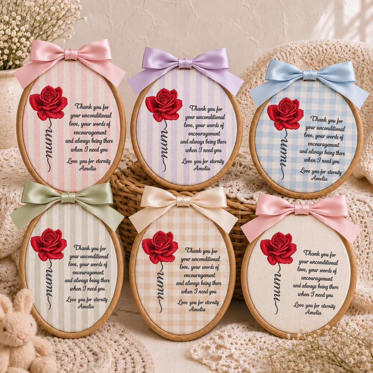 May include: Six oval wooden embroidery hoops featuring fabric backgrounds with stripes or gingham patterns. Each hoop displays a red rose illustration, the word mum, and a printed message of gratitude signed by Amelia, topped with a satin bow.