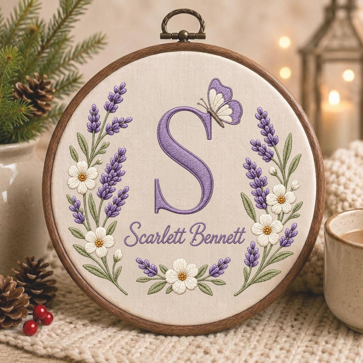 May include: A circular wooden embroidery hoop containing cream-colored fabric with a hand-stitched design. The design features a large purple letter S, a small purple and white butterfly, lavender sprigs, white flowers, and the name Scarlett Bennett.