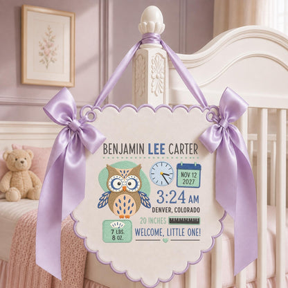 May include: A cream-colored scalloped wall hanging featuring a brown owl illustration, the name Benjamin Lee Carter, a clock showing 3:24 AM, a calendar date of Nov 12 2027, 7 lbs 8 oz, 20 inches, and the text Welcome, Little One, tied with lavender ribbons.