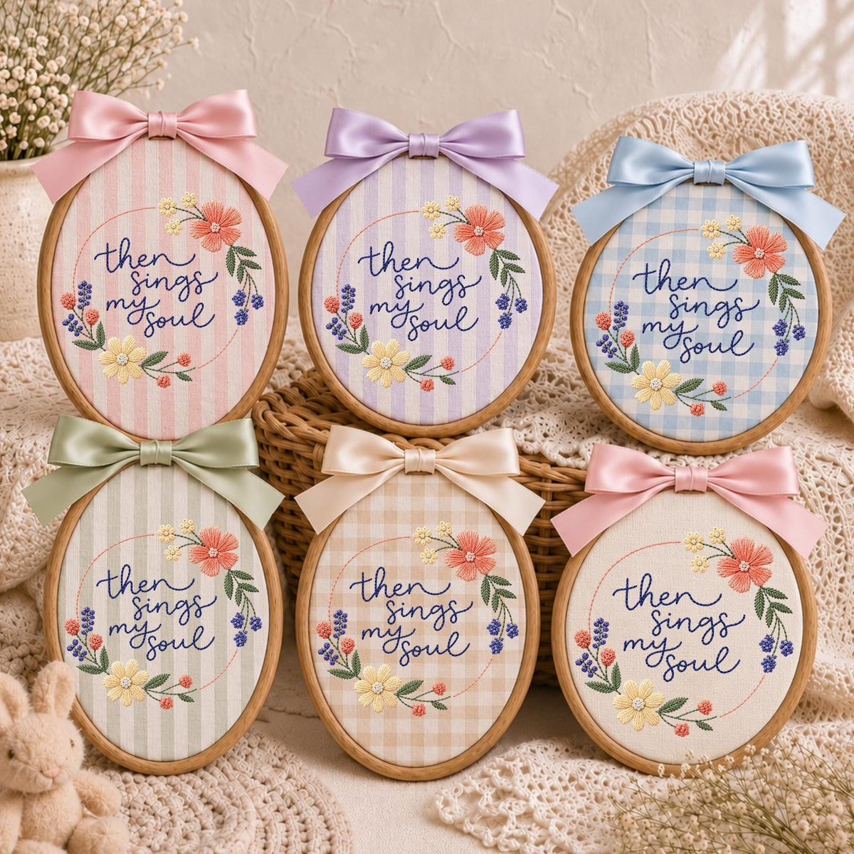 May include: Six oval embroidery hoops featuring the embroidered text 'then sings my soul' surrounded by floral wreaths. Each hoop is topped with a satin ribbon bow and displays a unique fabric background, including stripes, gingham, and solid patterns.